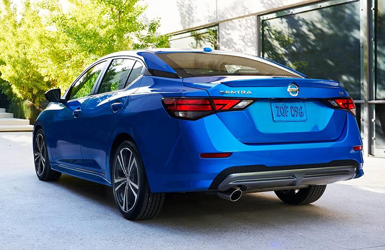 Attractive rear end of a blue 2020 Nissan Sentra parked on a sunny day.
