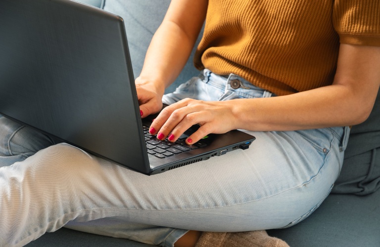 Person car shopping on a laptop